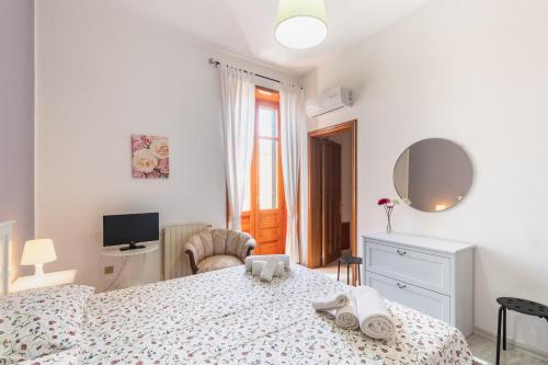 ein weißes Schlafzimmer mit einem Bett und einem Schreibtisch in der Unterkunft Casa Mia in Avola
