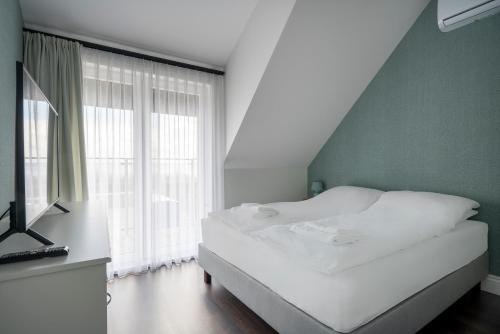 מיטה או מיטות בחדר ב-W Starym Porcie Krynica Morska