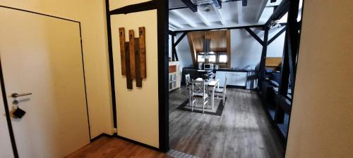 an open door to a room with a table and a kitchen at FEWO im alten Bahnhof in Niederroßbach