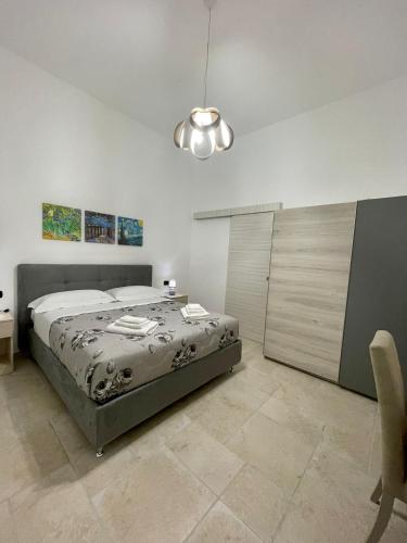 a bedroom with a bed and a desk and a bed sidx sidx sidx at B&B La Piazzetta in Fragagnano