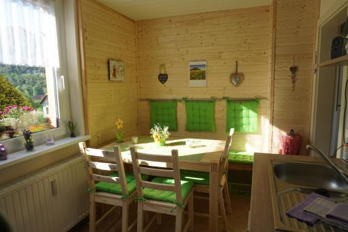 a kitchen with a table and chairs in a room at Ferienwohnung Familie Frank in Kurort Rathen