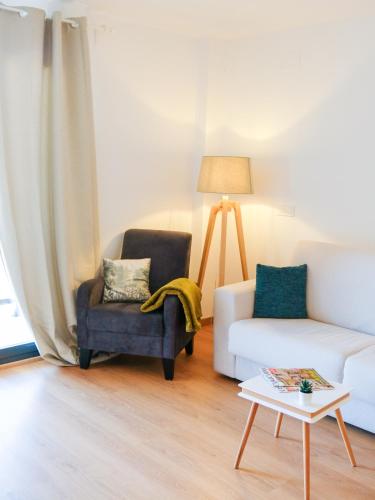 a living room with a couch and a chair and a table at El Portal de María in Aínsa