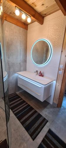 a bathroom with a sink and a mirror at Domek Mazury - Jezioro Orzysz in Orzysz