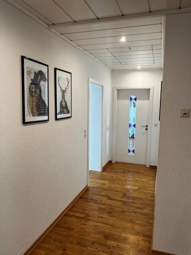 a hallway with three framed pictures on a wall at Hotel Colosseum in Rheinböllen