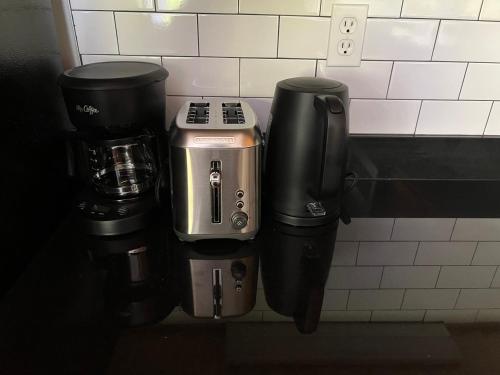 a group of coffee machines sitting on a wall at Downtown Norfolk Loft in Norfolk