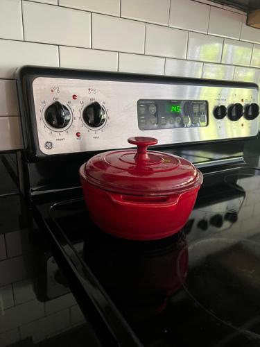 a red pot sitting on top of a stove at Downtown Norfolk Loft in Norfolk