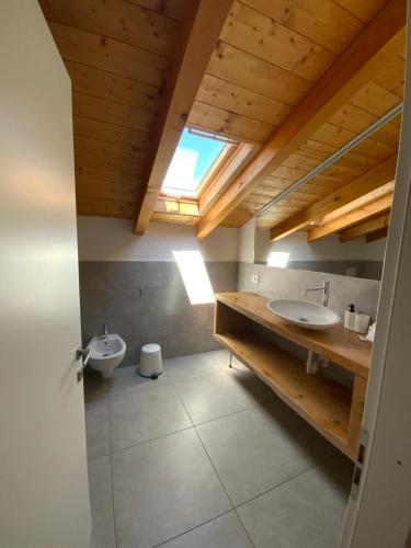 a bathroom with a sink and a toilet in it at Verdepiano Bed & Camping in Riva del Garda