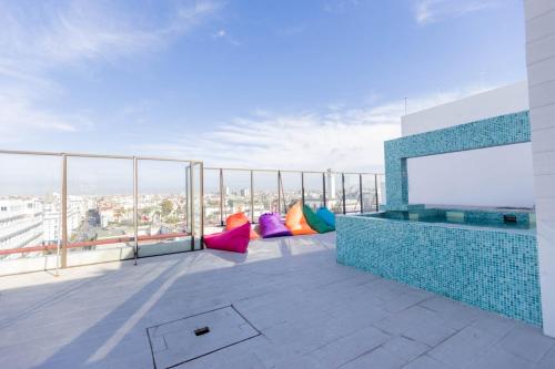 a balcony with colorful pillows on top of a building at Prince de Paris in Casablanca