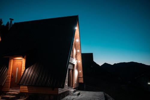 a house with a black roof at night at Villa Route Rugove in Peje