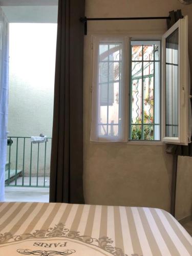 a bedroom with a bed and a window at Vieil Antibes, ravissant 2p avec petite terrasse in Antibes