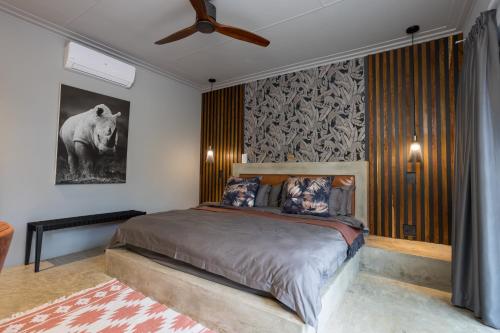 a bedroom with a bed and a ceiling fan at Muunga Bush Lodge & Spa in Hoedspruit