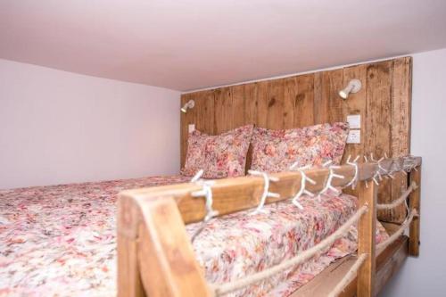 a bed with a wooden headboard in a room at Eliora Studio & Aelia Apartment in Heraklio Town
