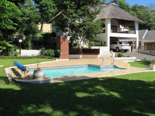 a swimming pool in front of a house at 3 Lagoon Getaways in Southbroom