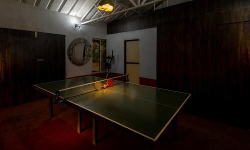 a ping pong table in a room with a ping pong ball at SaffronStays Meadowbrook, Panvel - pet-friendly villa near Karnala Bird Sanctuary in Āpta