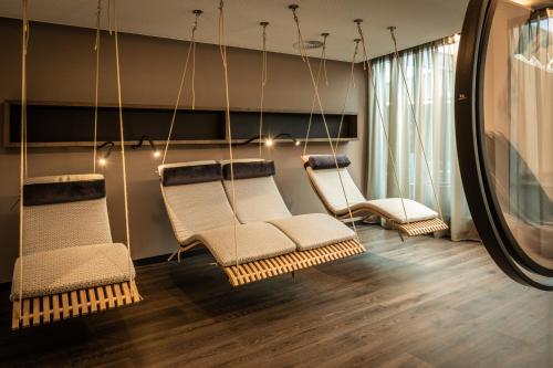 a room with three chairs and a mirror at Moselschlösschen Spa & Resort in Traben-Trarbach