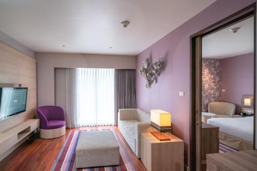 a hotel room with a bed and a tv at Holiday Inn Express Phuket Patong Beach Central by IHG in Patong Beach