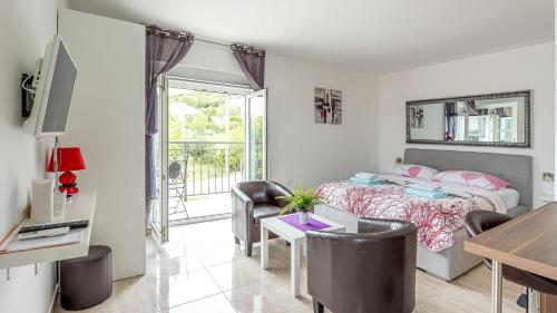 a bedroom with a bed and a table and chairs at Apartments Klara in Senj