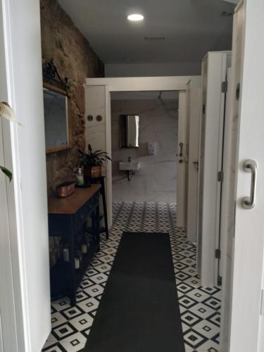 a bathroom with a sink and a toilet in a room at Albergue Aldea da Pedreira in Teo