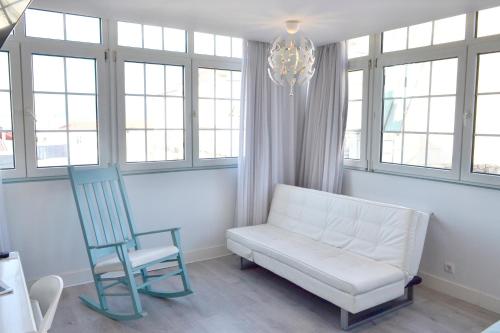 a living room with a white couch and a chair at Hotel Alda Puerta Del Sol in Vigo