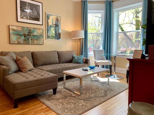 a living room with a couch and a table at 1F Cozy Home in Little Italy near Downtown West Loop United Center in Chicago