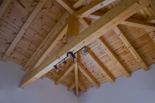 a wooden ceiling with a light hanging from it at Stonehouse with wonderful seaview in Samos