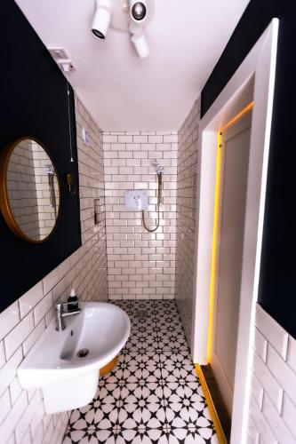 a white bathroom with a sink and a mirror at Stay Barrow Blueway - The Stables in Monasterevin
