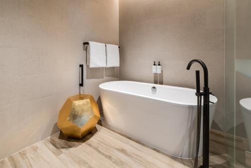 a bathroom with a white tub and a sink at InterContinental Perth City Centre by IHG in Perth