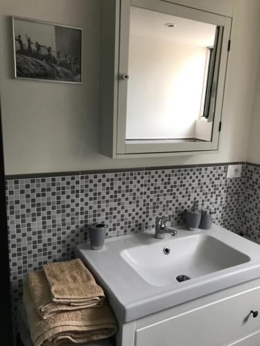 a bathroom with a white sink and a mirror at RomaKumamoto in Rome