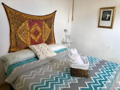 a bedroom with a bed with a pillow and a blanket at La casa del Sur in Granada