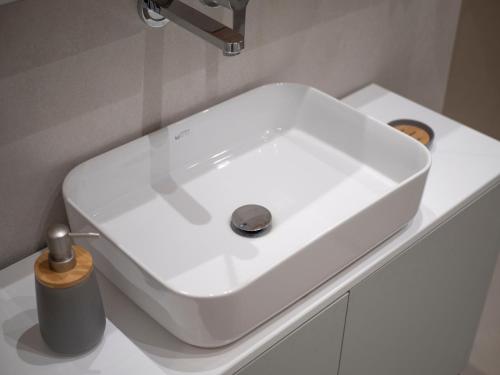 a white sink sitting on a counter in a bathroom at Horizon-One bedroom apartment with pool Jane in Becici