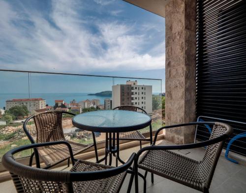 a table and chairs on a balcony with a view at Horizon-One bedroom apartment with pool Jane in Becici