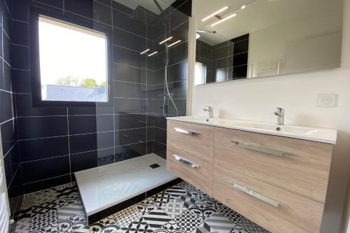 a bathroom with a sink and a mirror at carantec 4 stars villa with jacuzzi and garden for 8 persons in Carantec