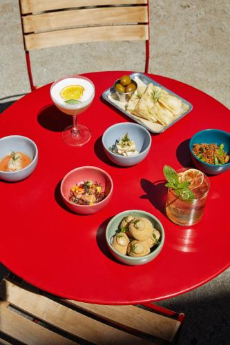 a red table with plates of food on top of it at Combo Milano in Milan