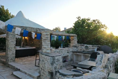 a stone house with a stone kitchen and a tent at לאורה in Umm el Shuf