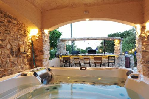 a jacuzzi tub in a room with a patio at לאורה in Umm el Shuf