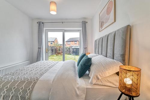 a bedroom with a large bed and a window at Guest Homes - Coney Green in Worcester