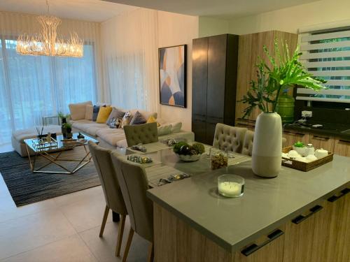 a kitchen and living room with a table and a couch at Luxury condo in cap cana in Punta Cana