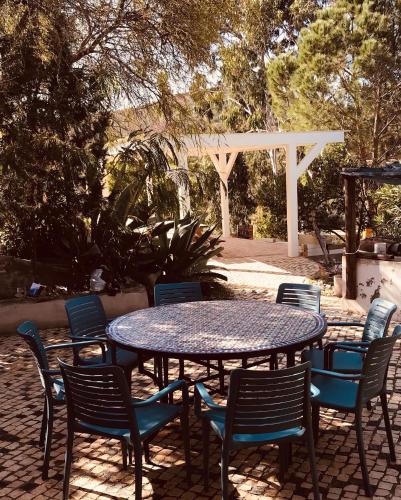 a table and chairs with a table and a white pergola at casa paz tavira in Tavira