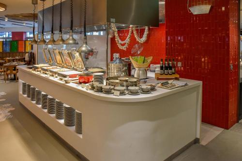 a counter in a restaurant with some food on it at Centara Mirage Beach Resort Dubai in Dubai