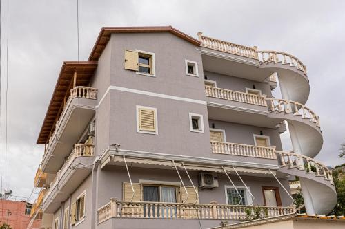 a building with balconies on the side of it at Villa The Old Bakery in Qeparo