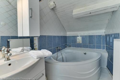 a bathroom with a tub and a toilet and a sink at Villa Lamartine in Aix-les-Bains