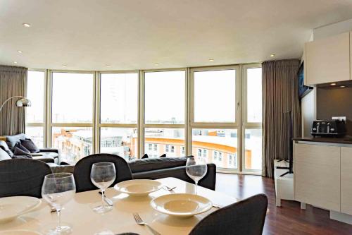 a living room with a table with wine glasses on it at Gunwharf Quays Apartments in Portsmouth