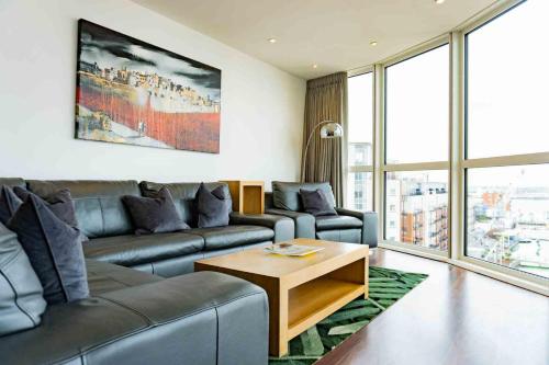 a living room with a couch and a table at Gunwharf Quays Apartments in Portsmouth