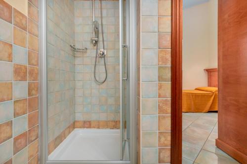 a bathroom with a shower with a tub at Il Nuovo Gabbiano in Cala Gonone