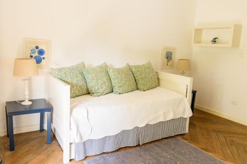 a white bed with pillows on it in a room at TW Guaimbê Exclusive Suítes in Ilhabela
