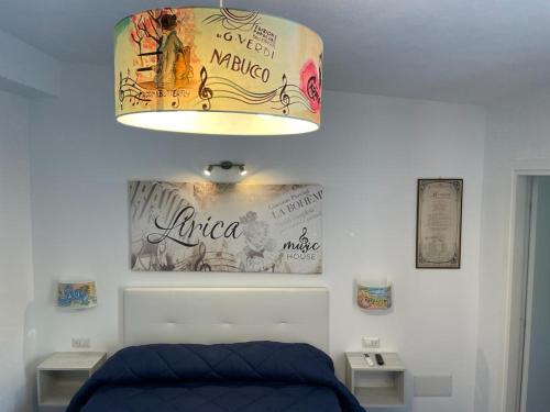 a bedroom with a blue bed and a lamp at Music House Palinuro in Palinuro