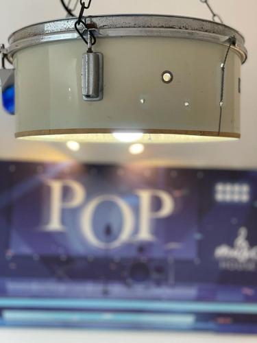 a light hanging from a ceiling in front of a laptop at Music House Palinuro in Palinuro