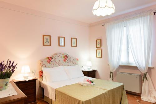 a bedroom with a bed and two windows at San Giovanni al Monte in Collazzone