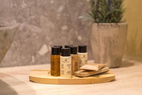 three bottles of essential oils sitting on a wooden holder at C Suites in Rethymno Town