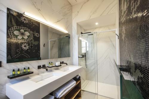 a bathroom with a sink and a shower at Château de Roquefoulet Luxury Guesthouse & Spa in Montgeard